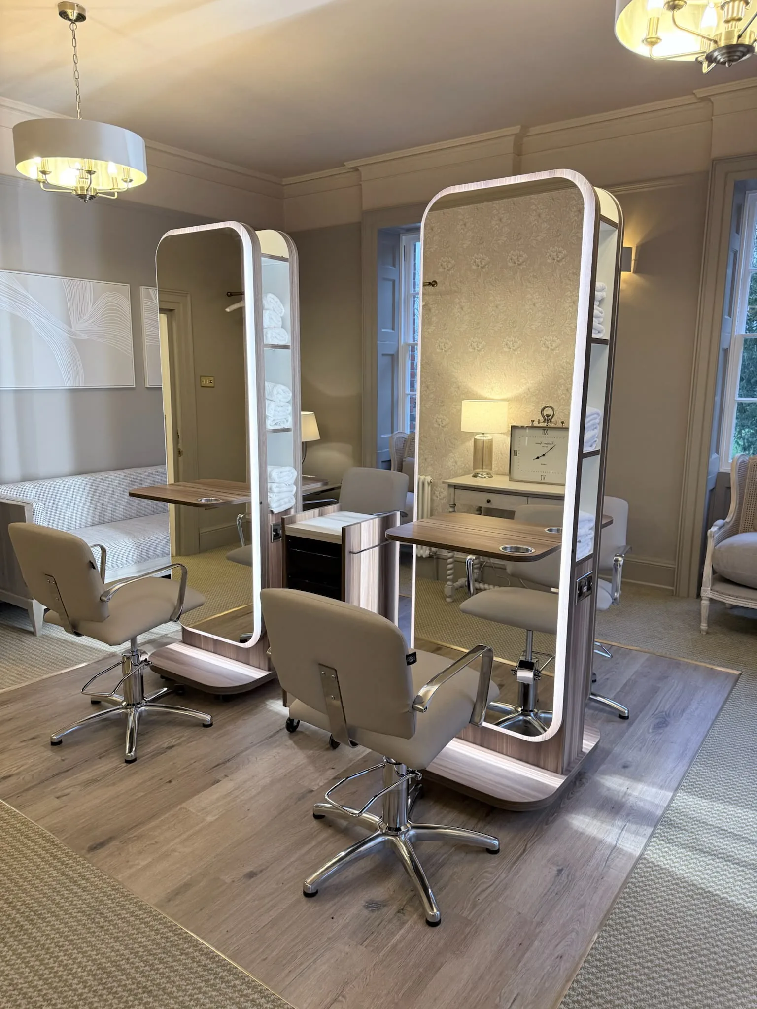 The Bridal Suite at Mulberry House, with freestanding lit mirrors, styling chairs and a seating area by sash windows